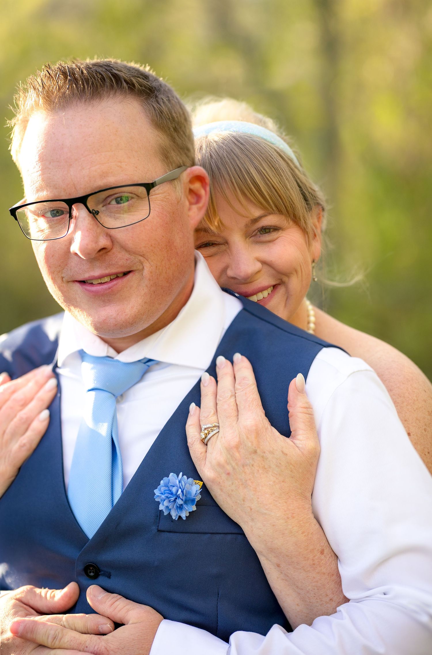 A sweet wedding moment captured in a series of photos showing a couple embracing in natural sunlit grove. Ottawa Wedding Photography