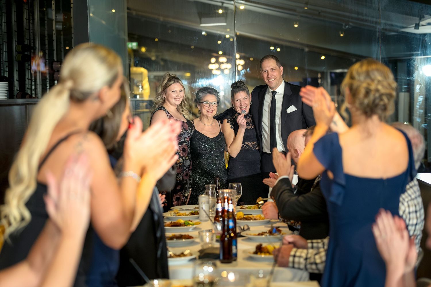 People celebrating at a REMAX event socialising in a dimly lit venue. Ottawa event Photographer Tim Gowling