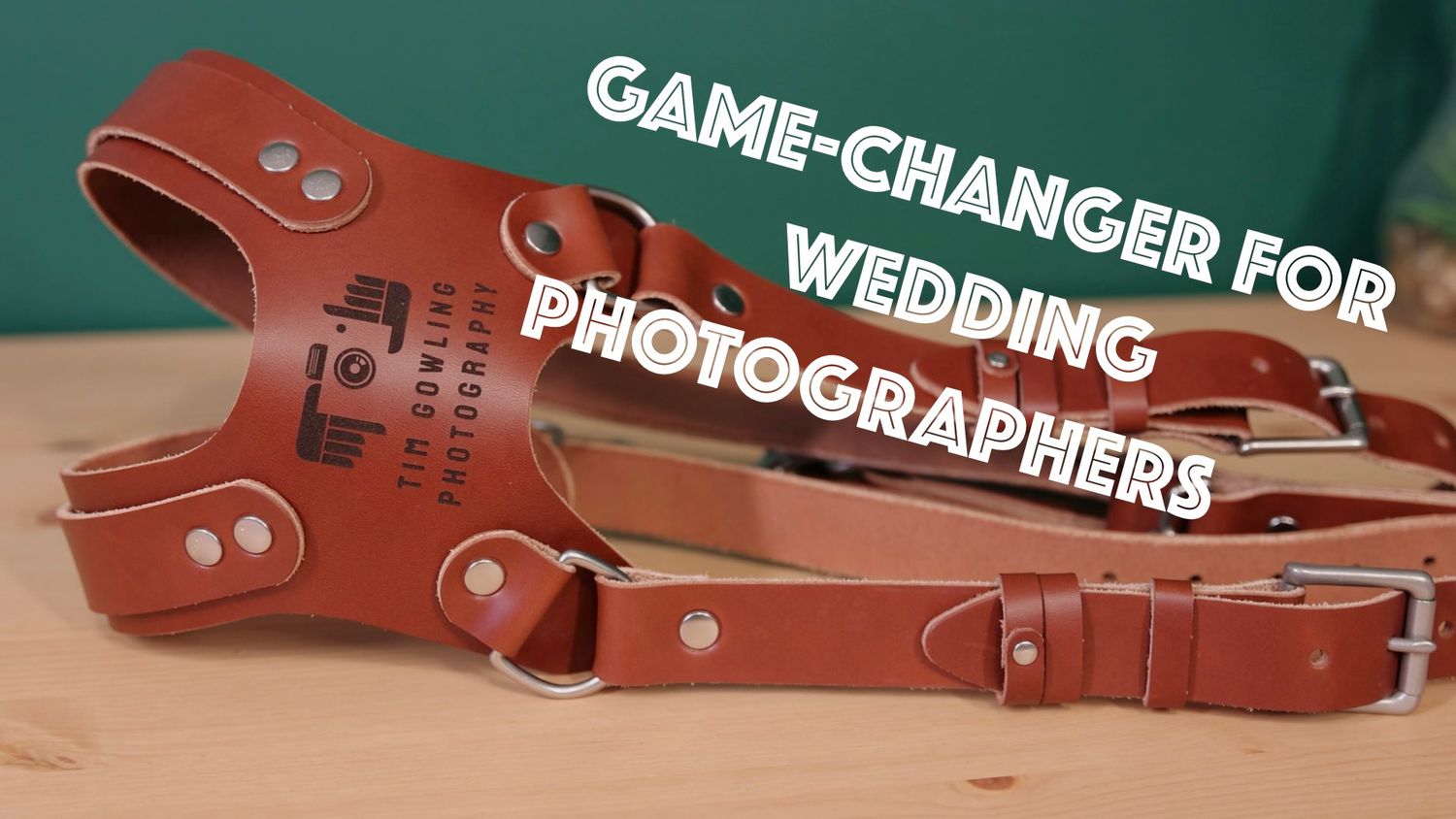 Brown leather dual camera harness with text overlay saying 'Game changer for wedding photographers'.