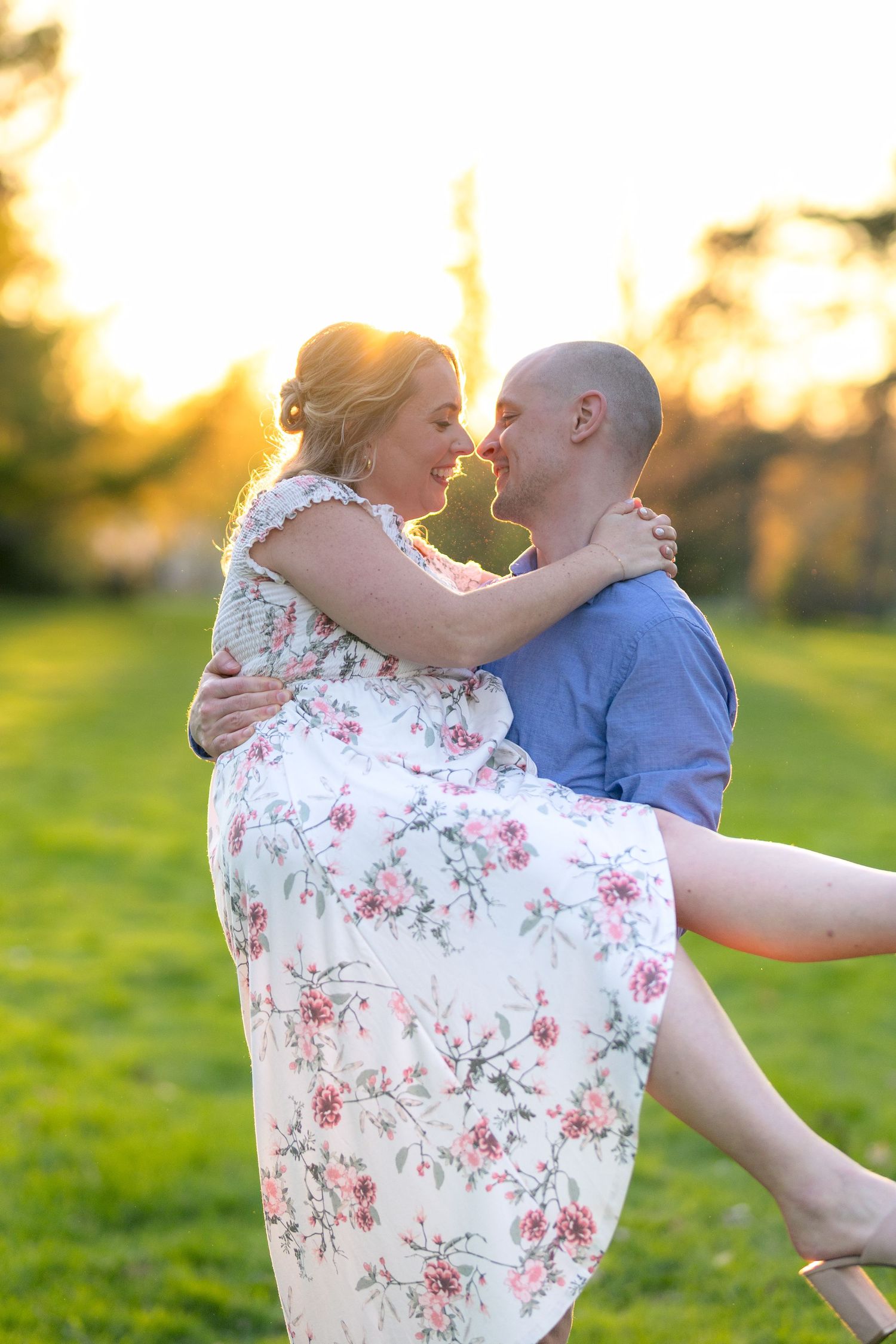 A playful moment captured as a couple dances in a sunlit field at sunset. Ottawa Wedding Photographer