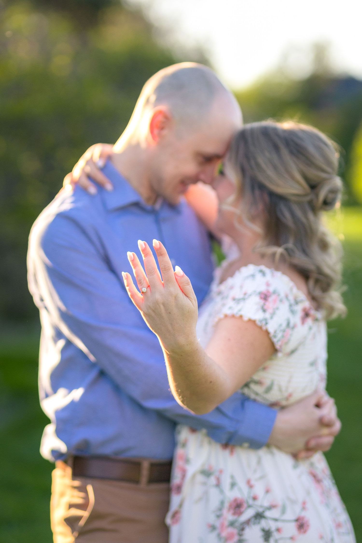 Joyful engagement moment captured in golden evening light showing ring. Ottawa Wedding Photographer
