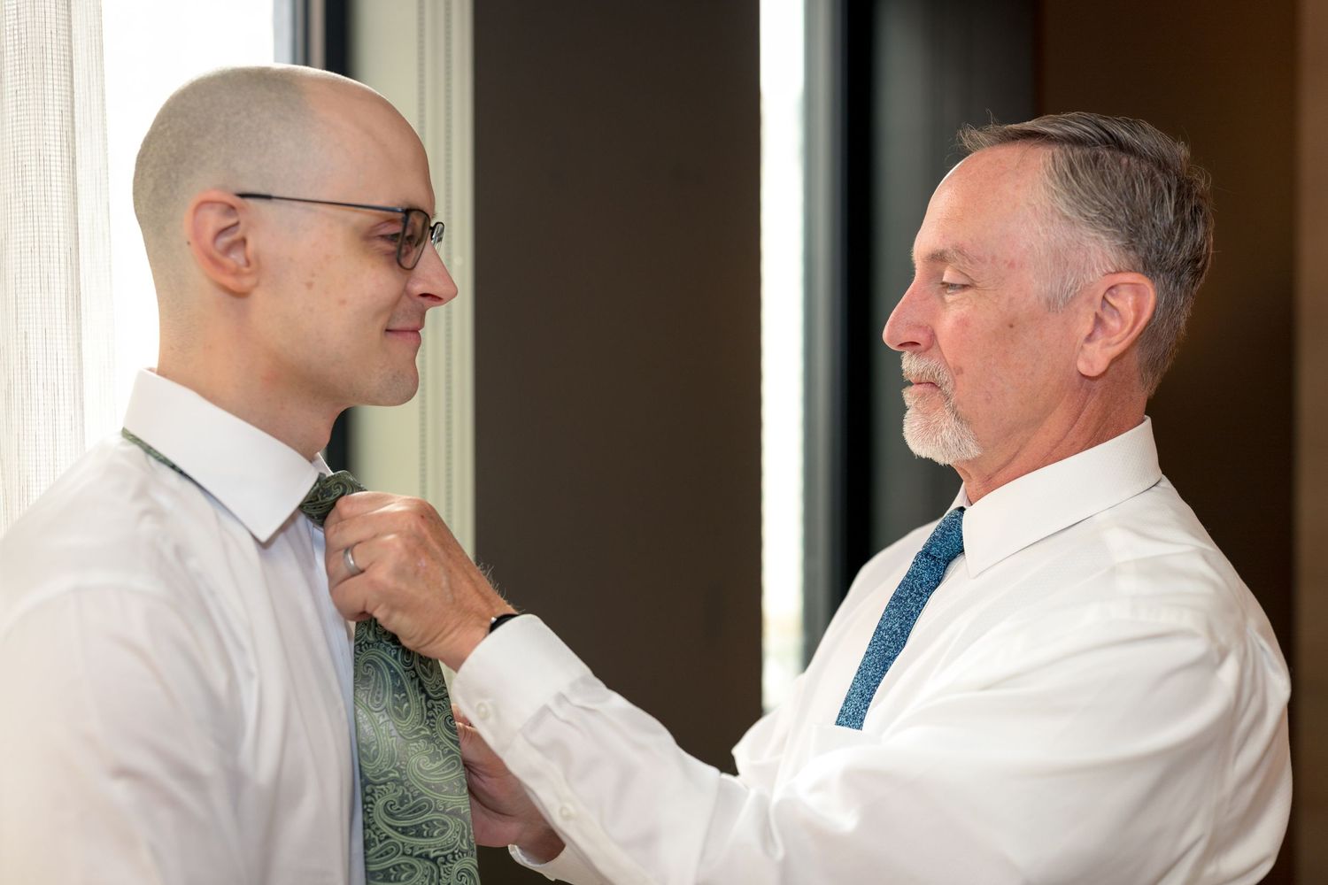 Father of the Groom helping the Groom with his Tie. Ottawa wedding Photographer