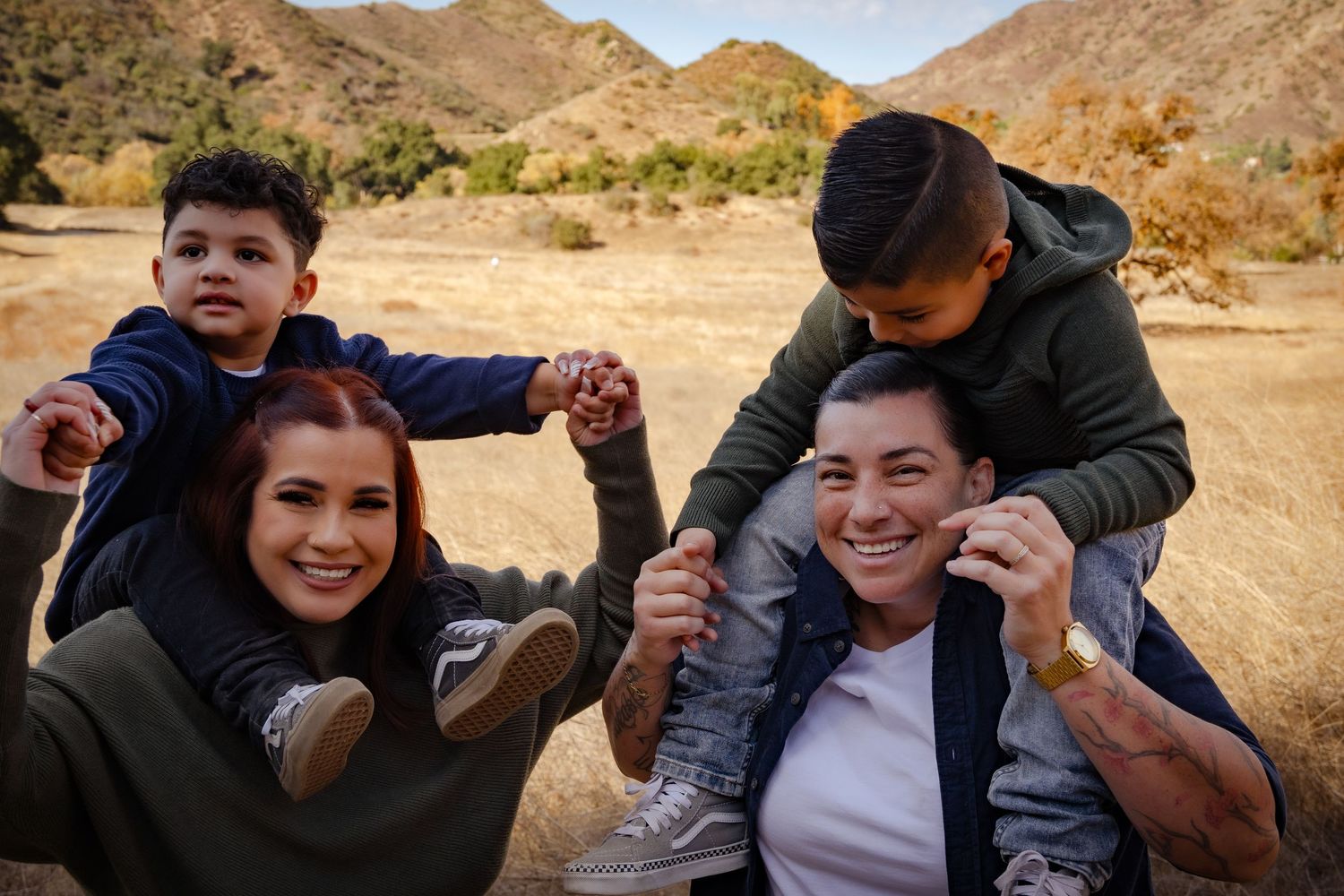 A group enjoys outdoor activities in a desert landscape with rocky mountains in the background.