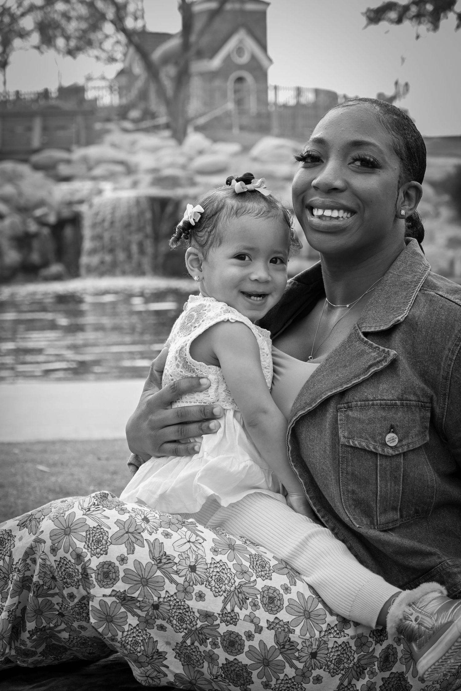 A heartwarming black and white photo series showing tender moments between a parent and child on a sunny day.