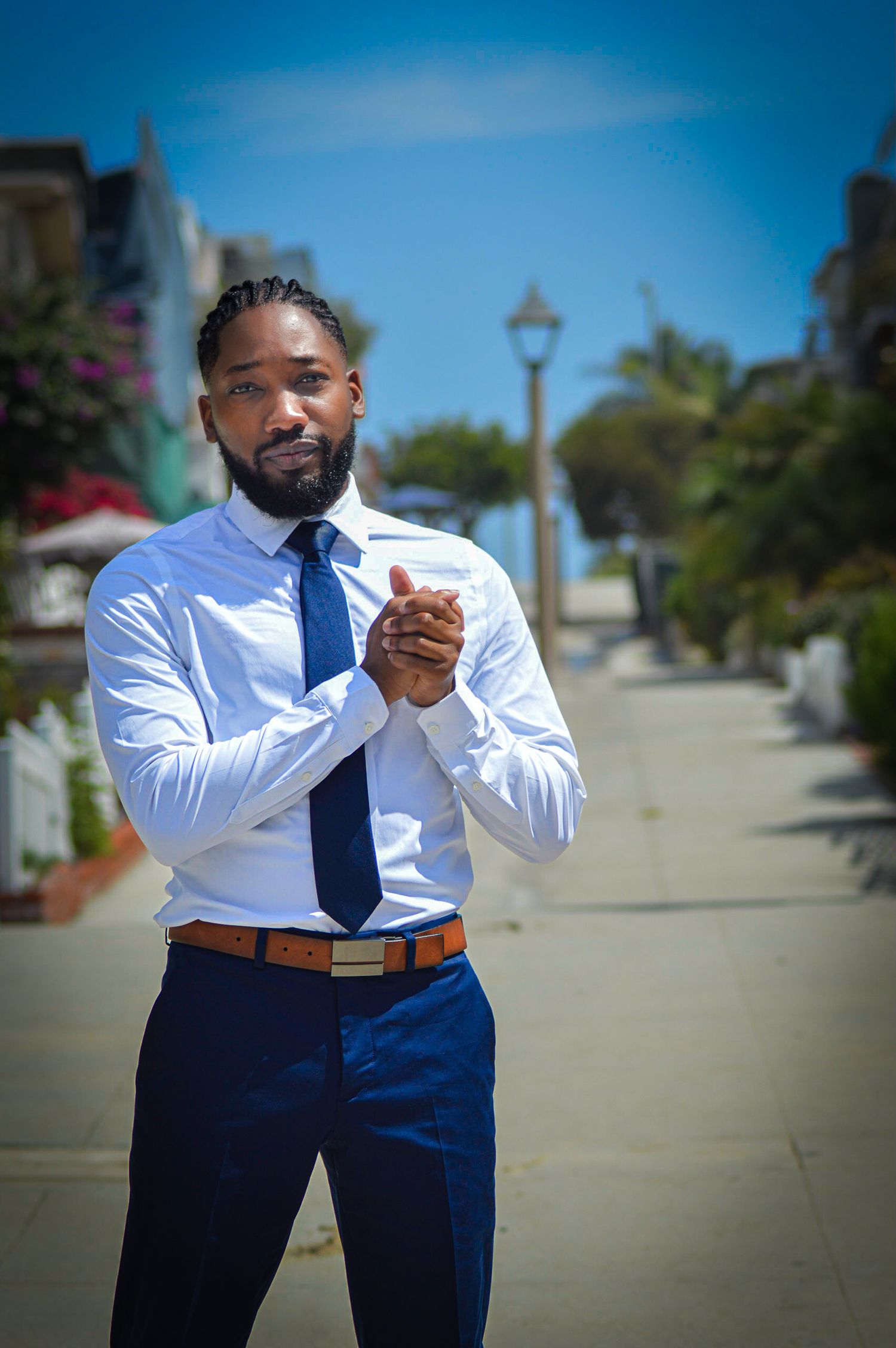 Professional in a crisp white dress shirt and navy slacks poses outdoors in a series of confident stances.