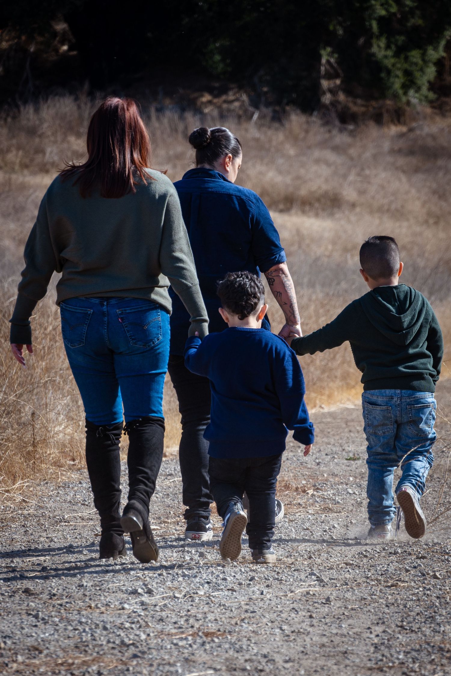 A sequence of images showing people walking together on a gravel path from behind in a natural outdoor setting.