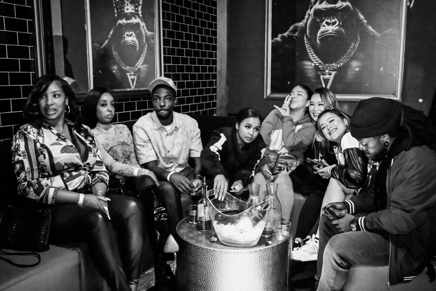 Black and white photo collage of people dancing and socializing at what appears to be a nightclub or party venue.