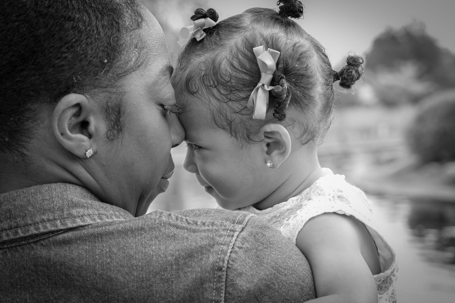 A tender black and white collage of intimate family moments showing love and affection between parent and child.