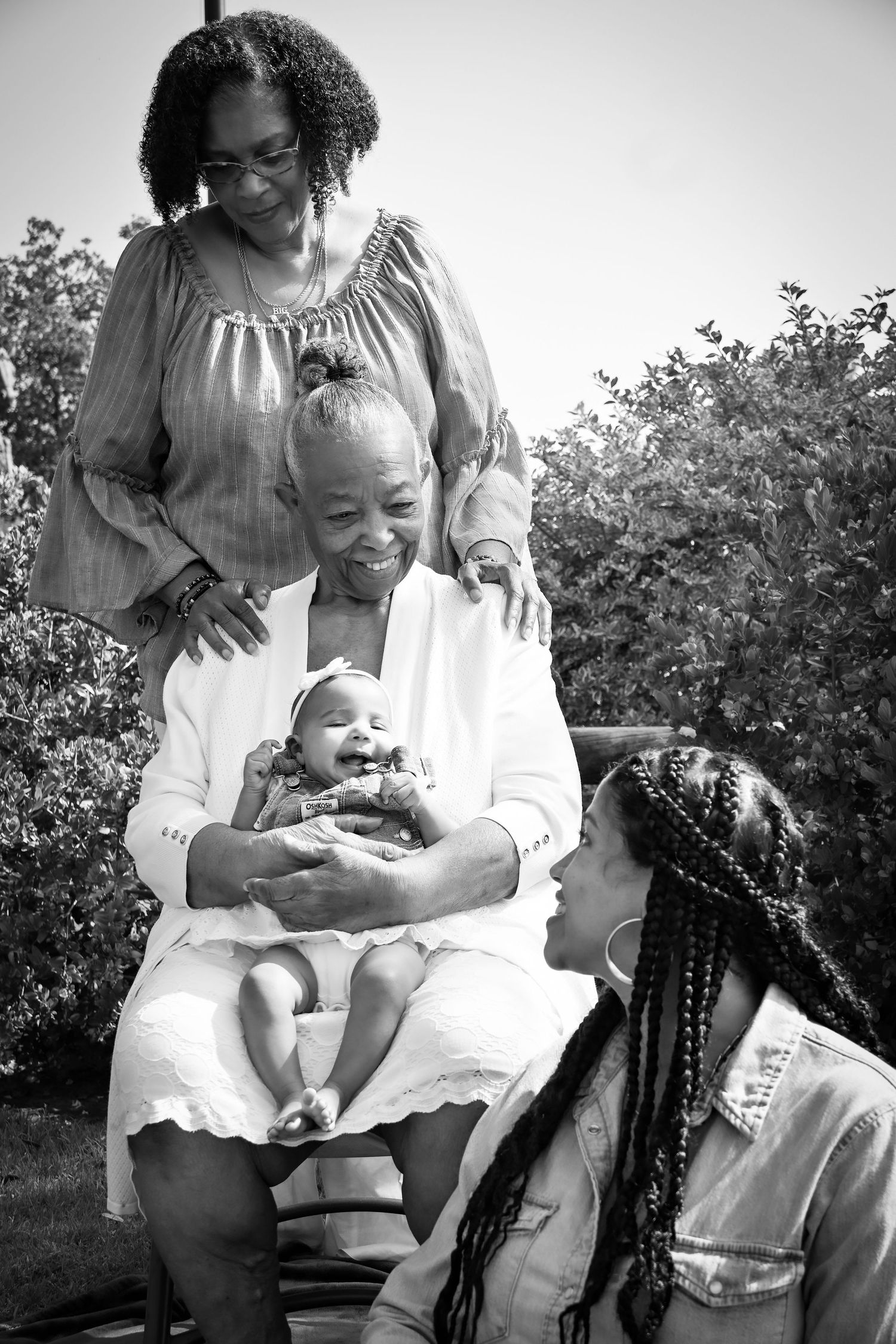 A heartwarming black and white photo series showing tender moments between a parent and child outdoors.