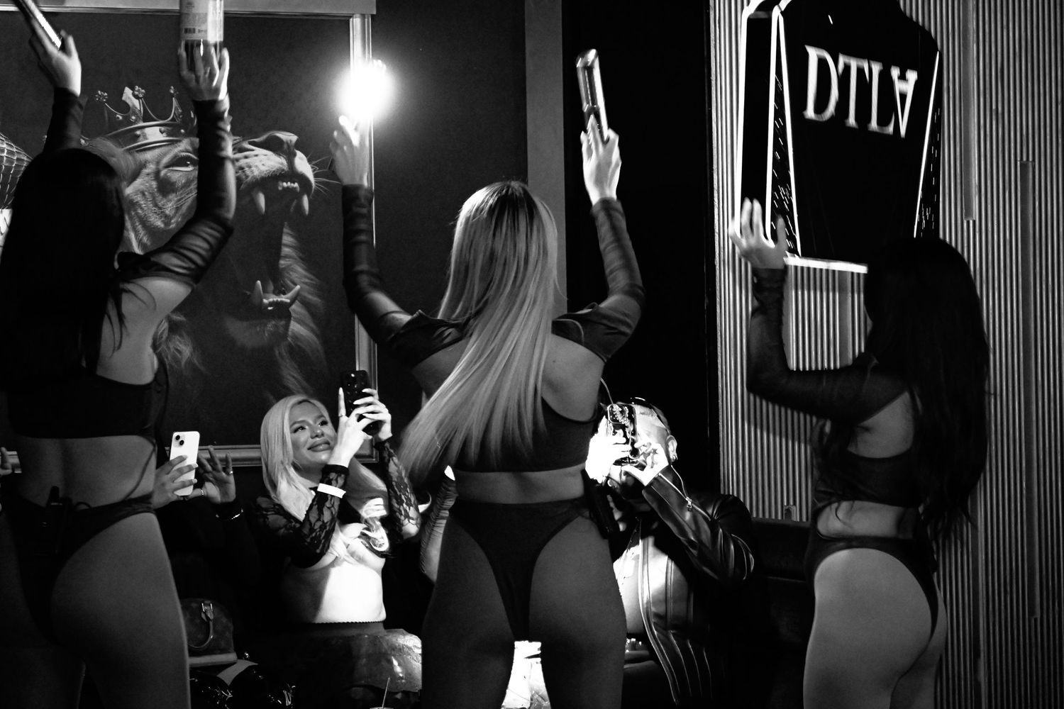 Black and white photo series showing people dancing and partying in a dimly lit nightclub setting.