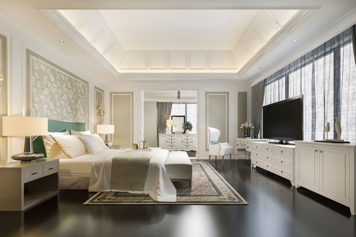 Elegant master bedroom with white furniture, dark hardwood floors, tray ceiling, flat-screen TV, and neutral decor.