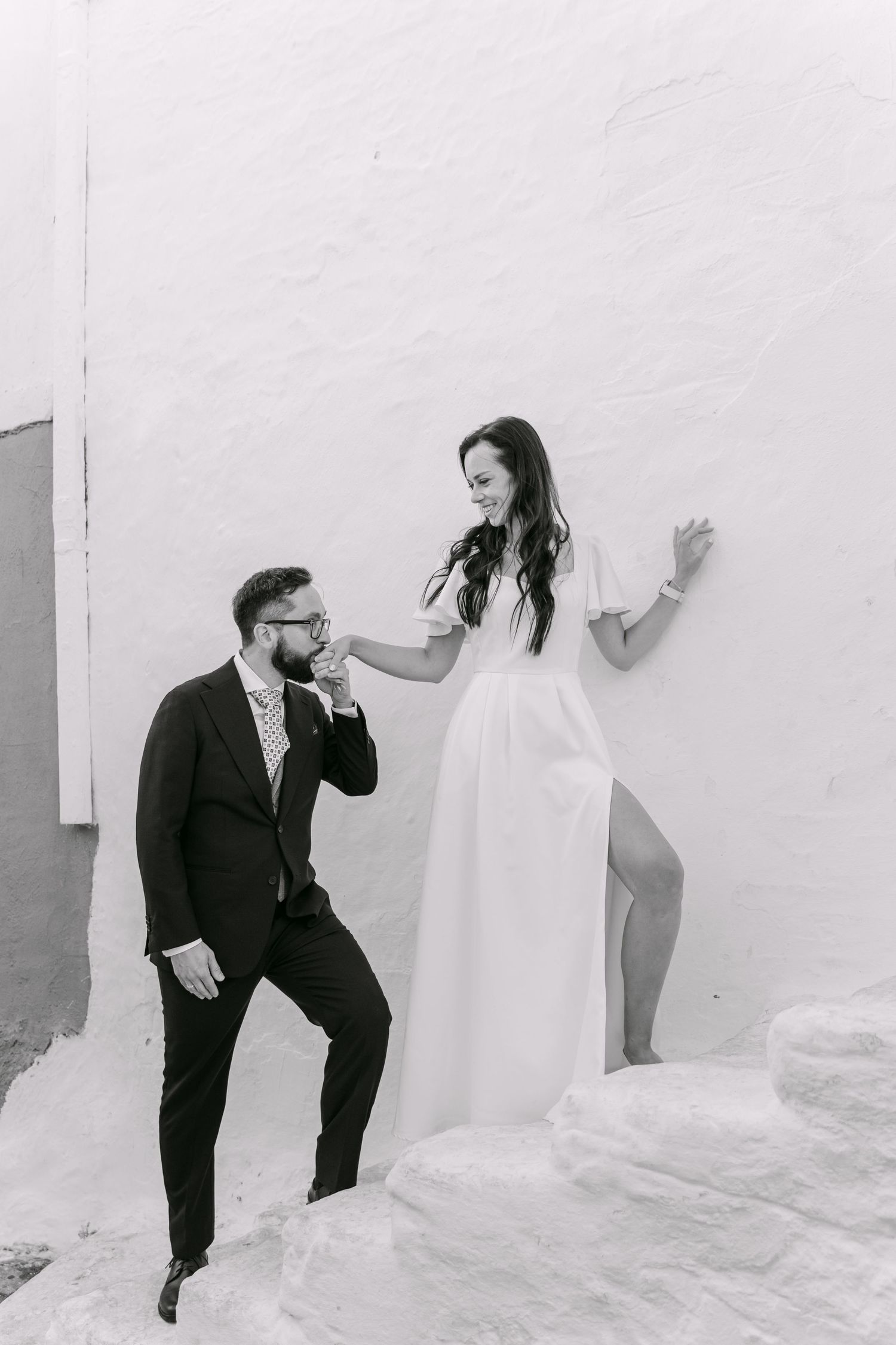 Black and white portrait of a couple on stone steps in Lindos, Rhodes.