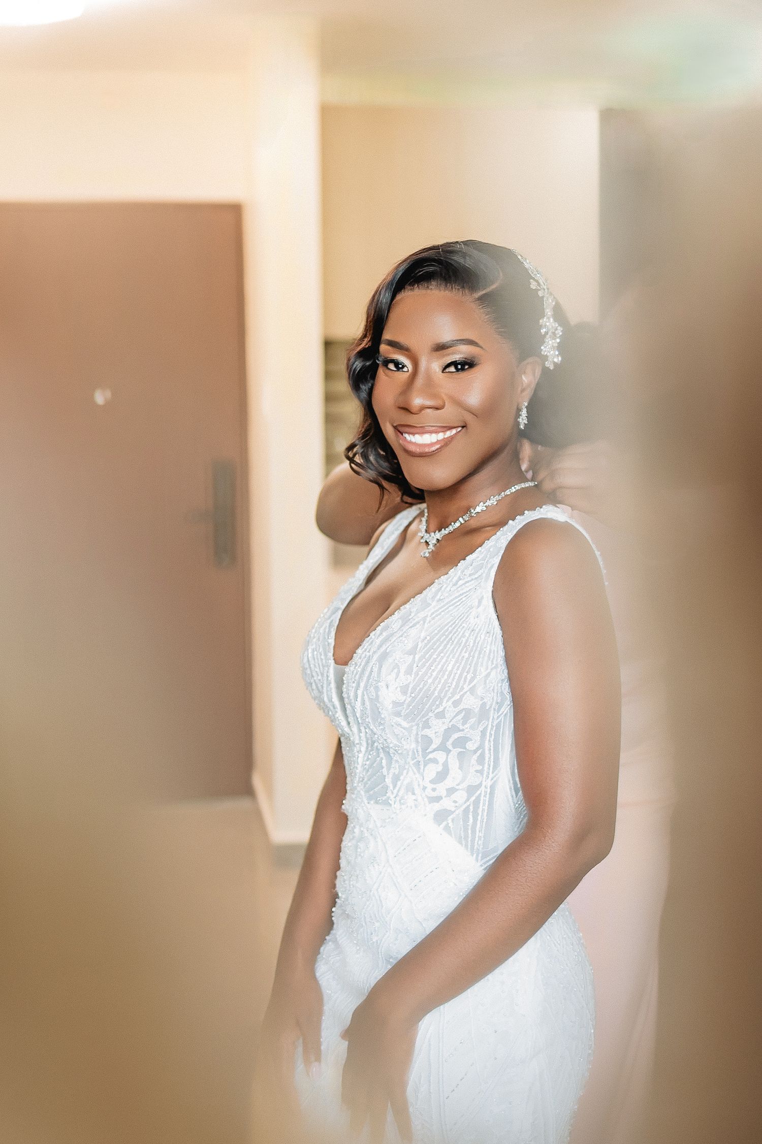 Soft focus wedding portraits showing joyful expressions in a light-filled setting.