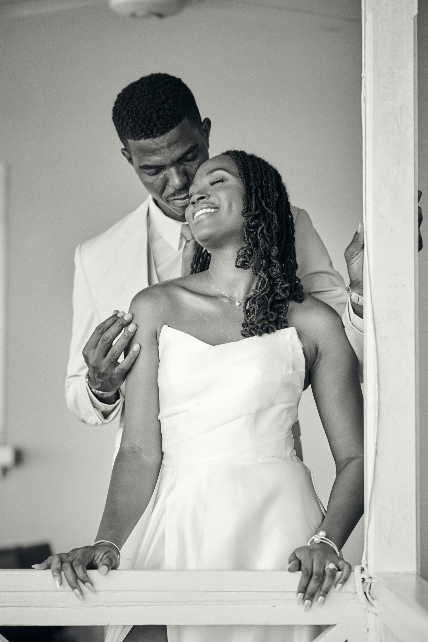 A romantic wedding photoshoot sequence showing tender moments between a couple in white attire.