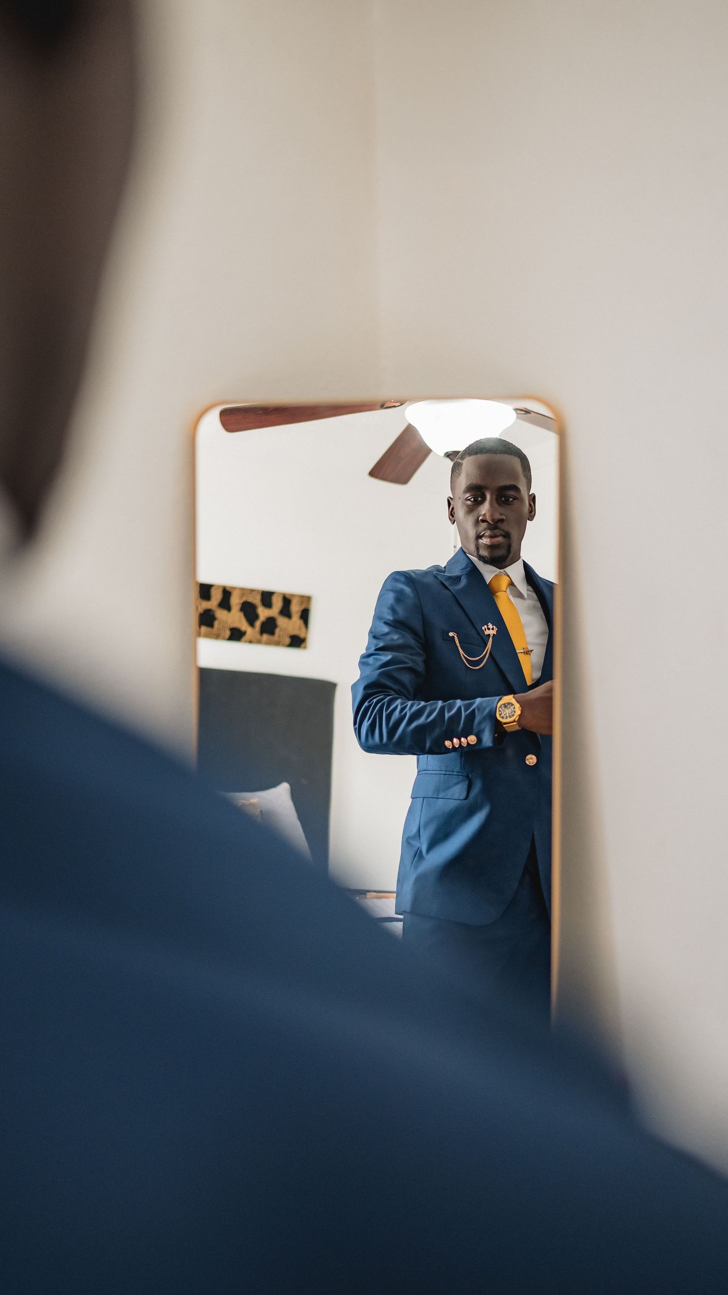 Wedding preparation scene showing formal attire reflected in a mirror.