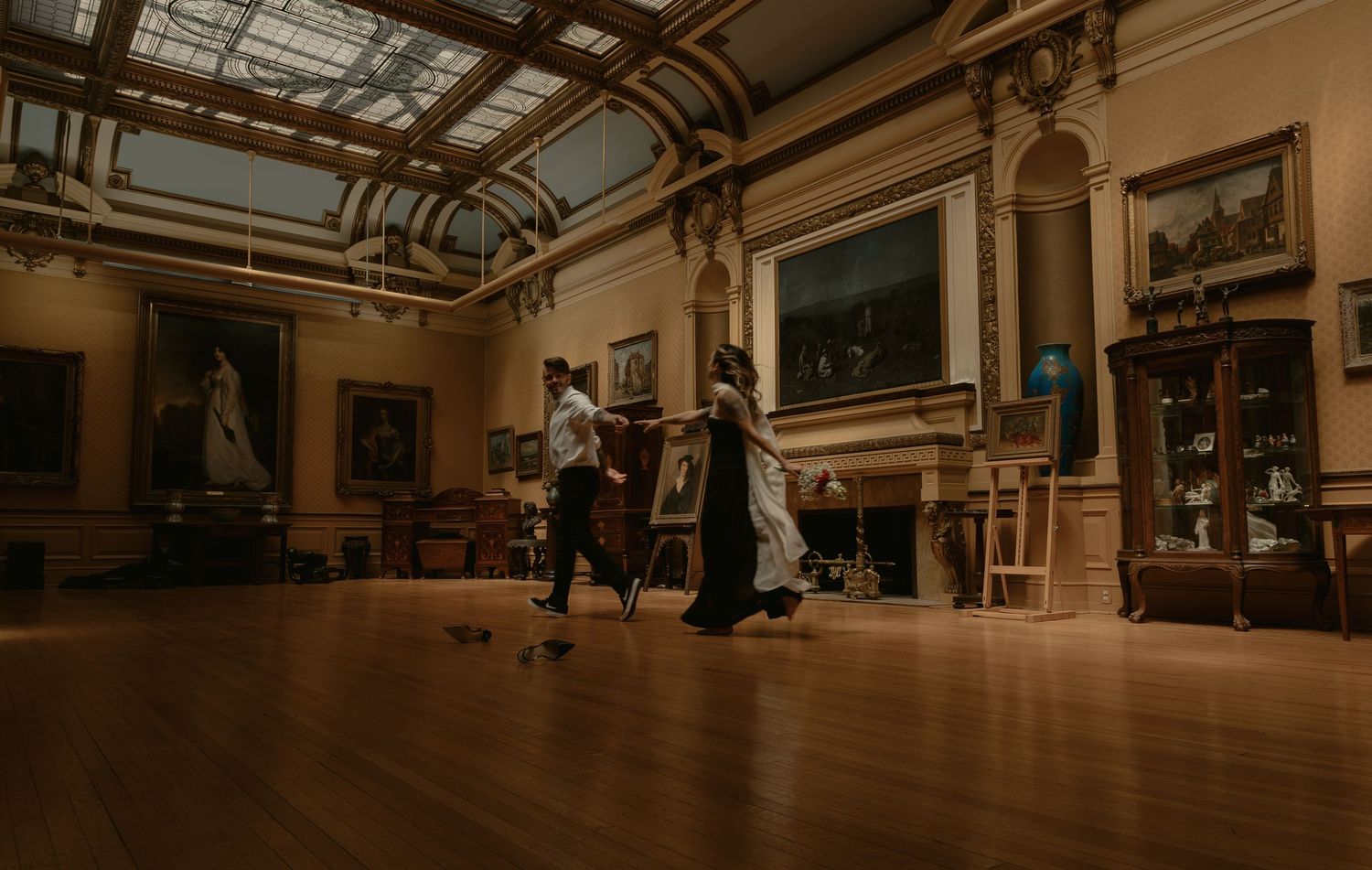 couple chasing each other through an art museum