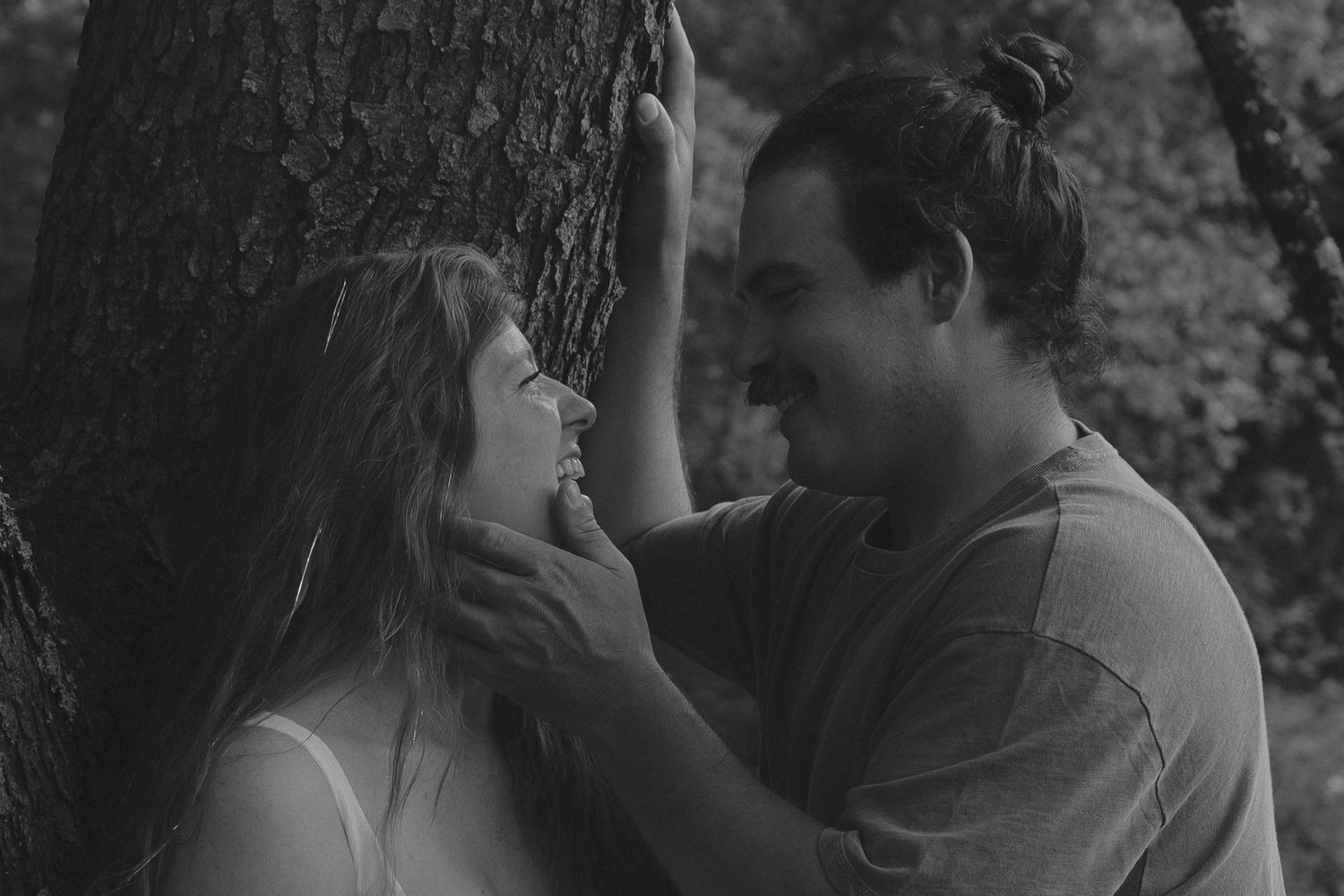couple cuddled up against a tree