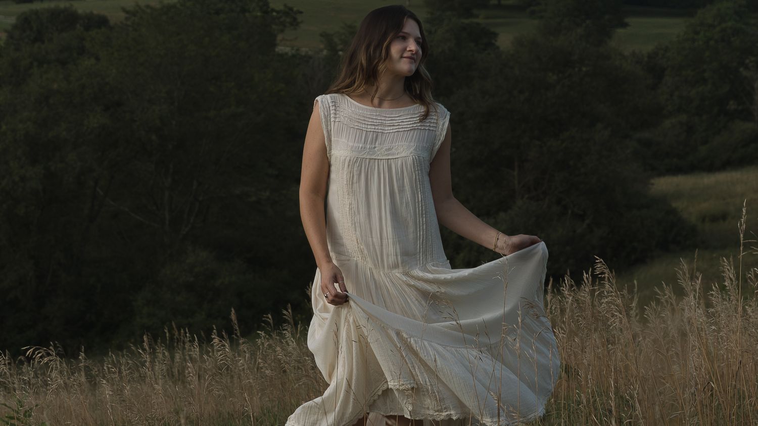 girl in a field twirling her dress