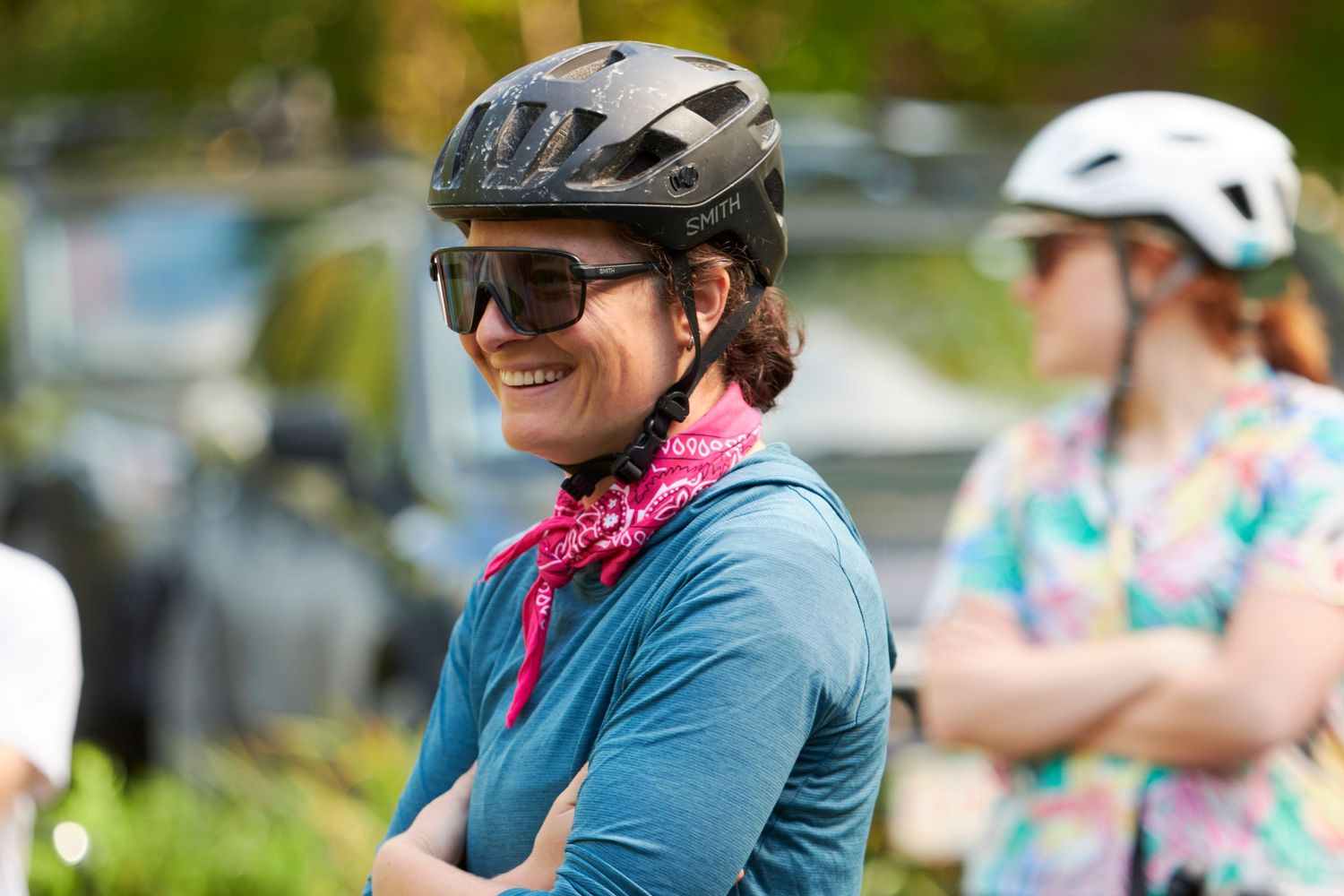 Cyclists gathered for an outdoor group ride on a sunny day.