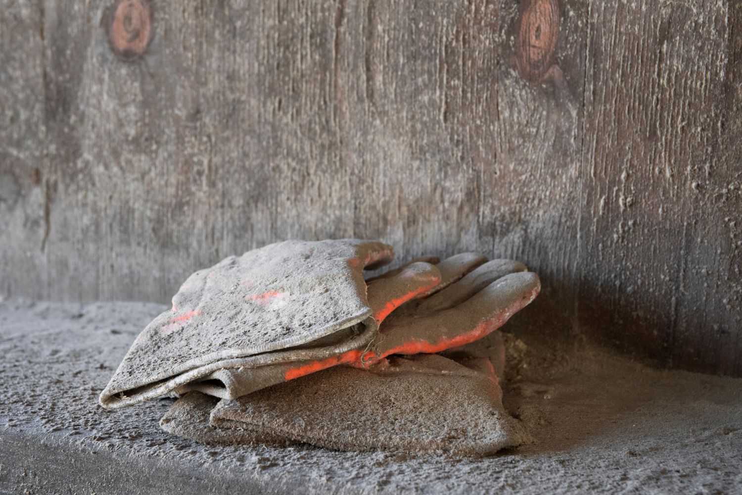 Rusty metal parts and debris scattered on a concrete floor.
