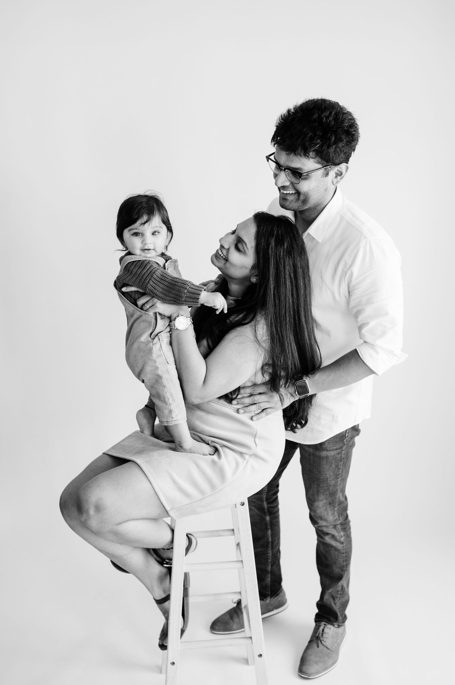 Black and white studio portraits showing tender family moments.
