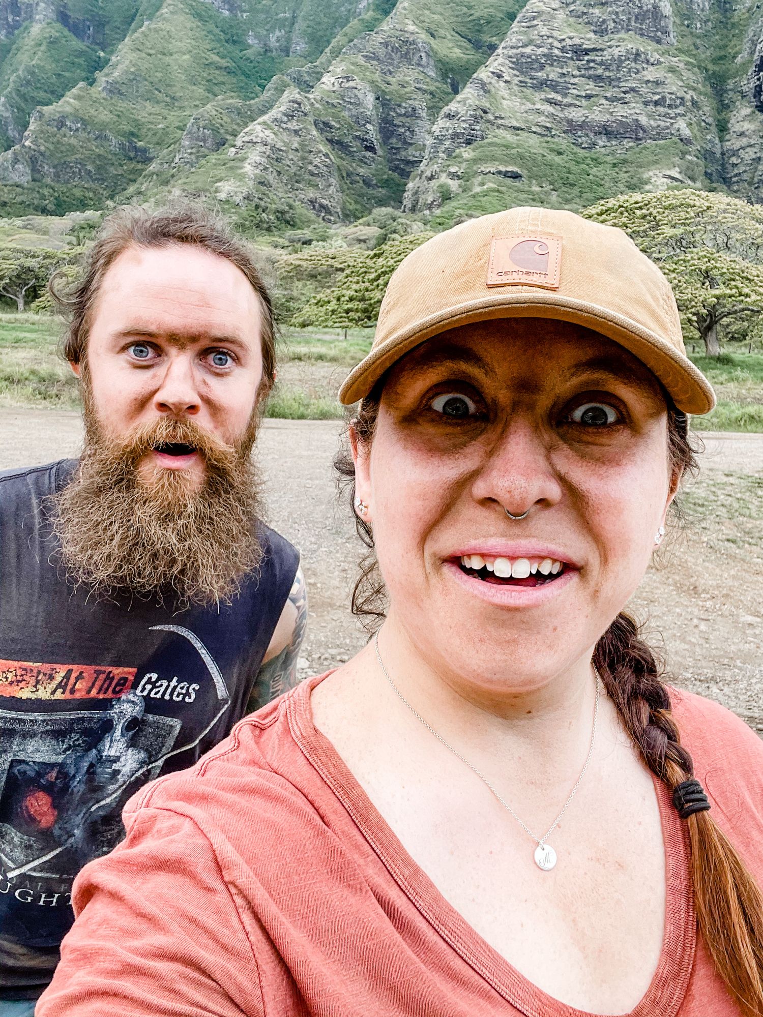 A series of selfie photos taken outdoors with mountains and green hills visible in the background.