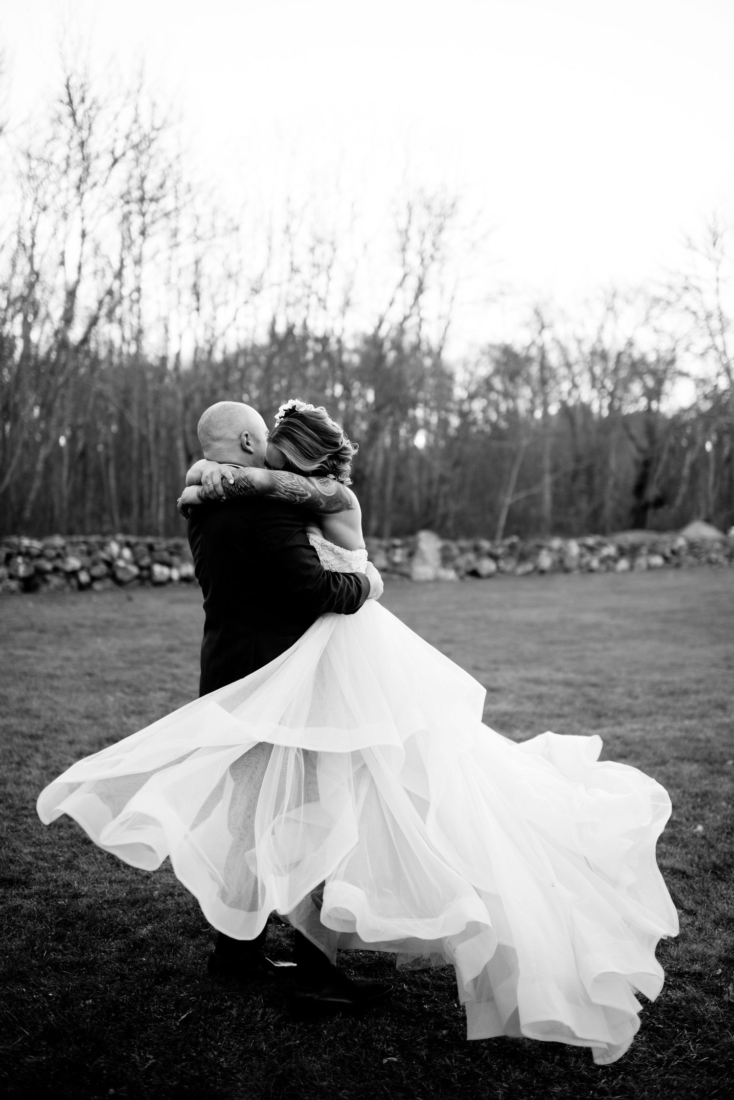 A black and white wedding photo sequence showing a flowing white dress twirling in an outdoor field.