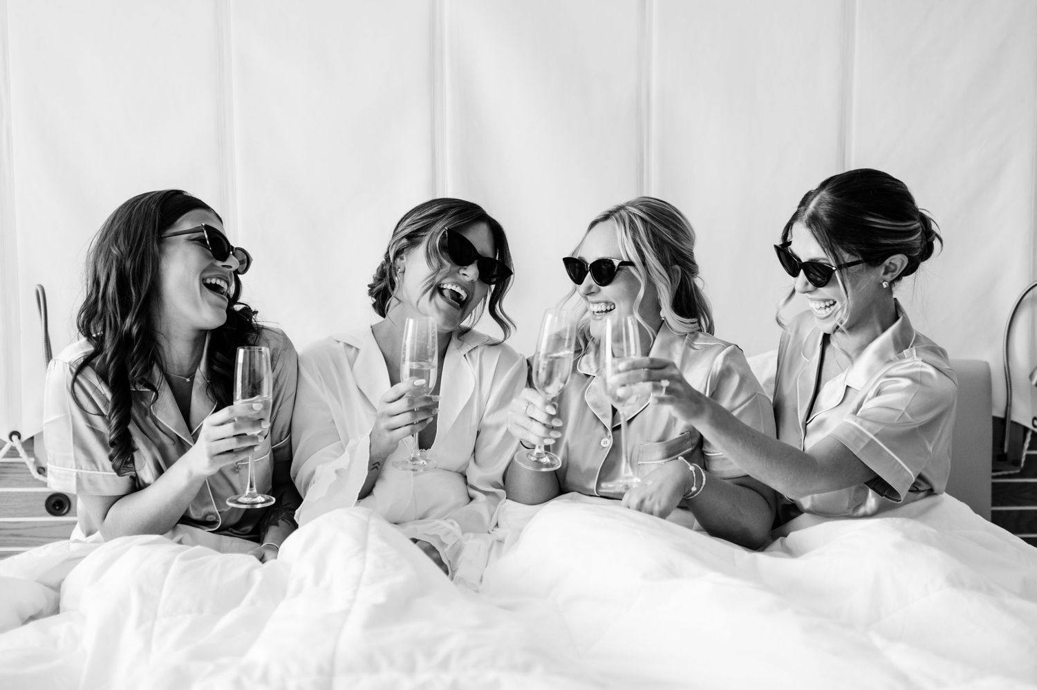 Black and white photo of joyful wedding party celebration.