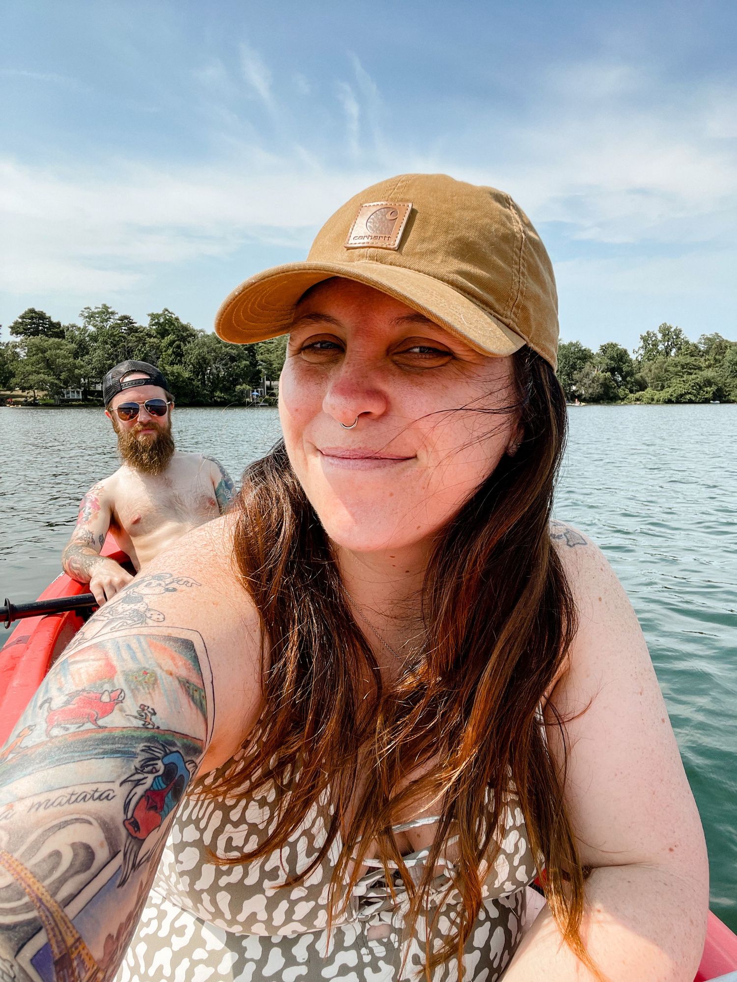 A series of selfies taken on a boat showing someone with brown hair and tattoos enjoying a sunny day on the water.