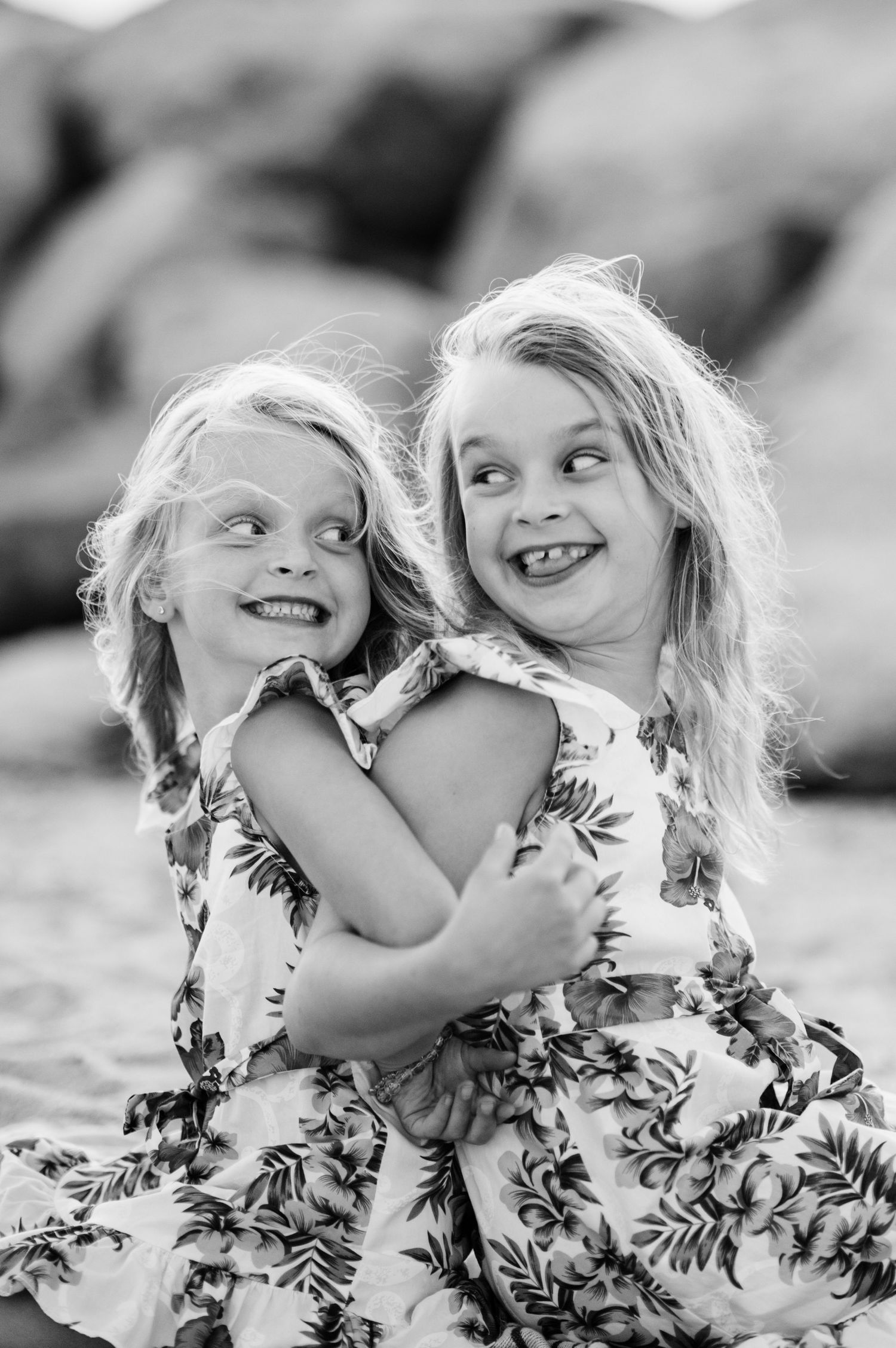 Close-up black and white portrait showing joyful expressions and laughter.