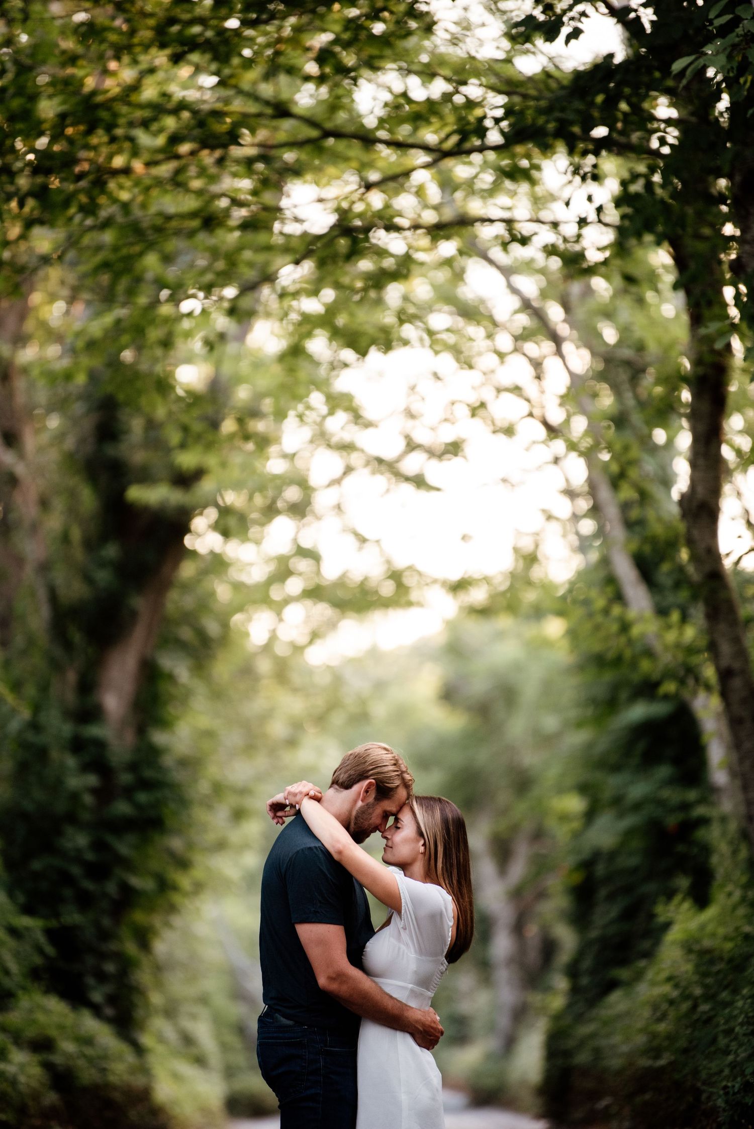A romantic woodland photoshoot with soft natural lighting filtering through trees.