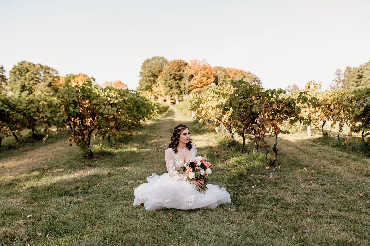 Panoramic sunset wedding photos showing a couple resting in a grassy field.