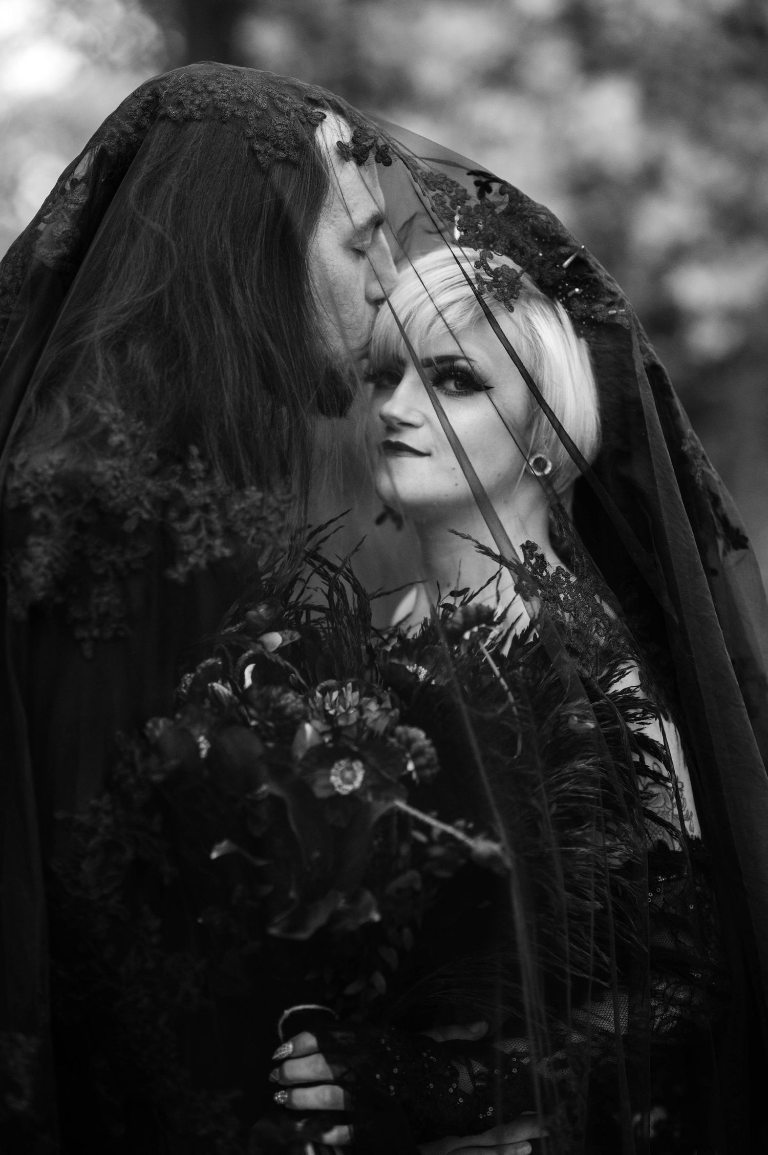 Artistic black and white portrait series featuring a woman in dark gothic styling with dramatic veil and lighting effects.