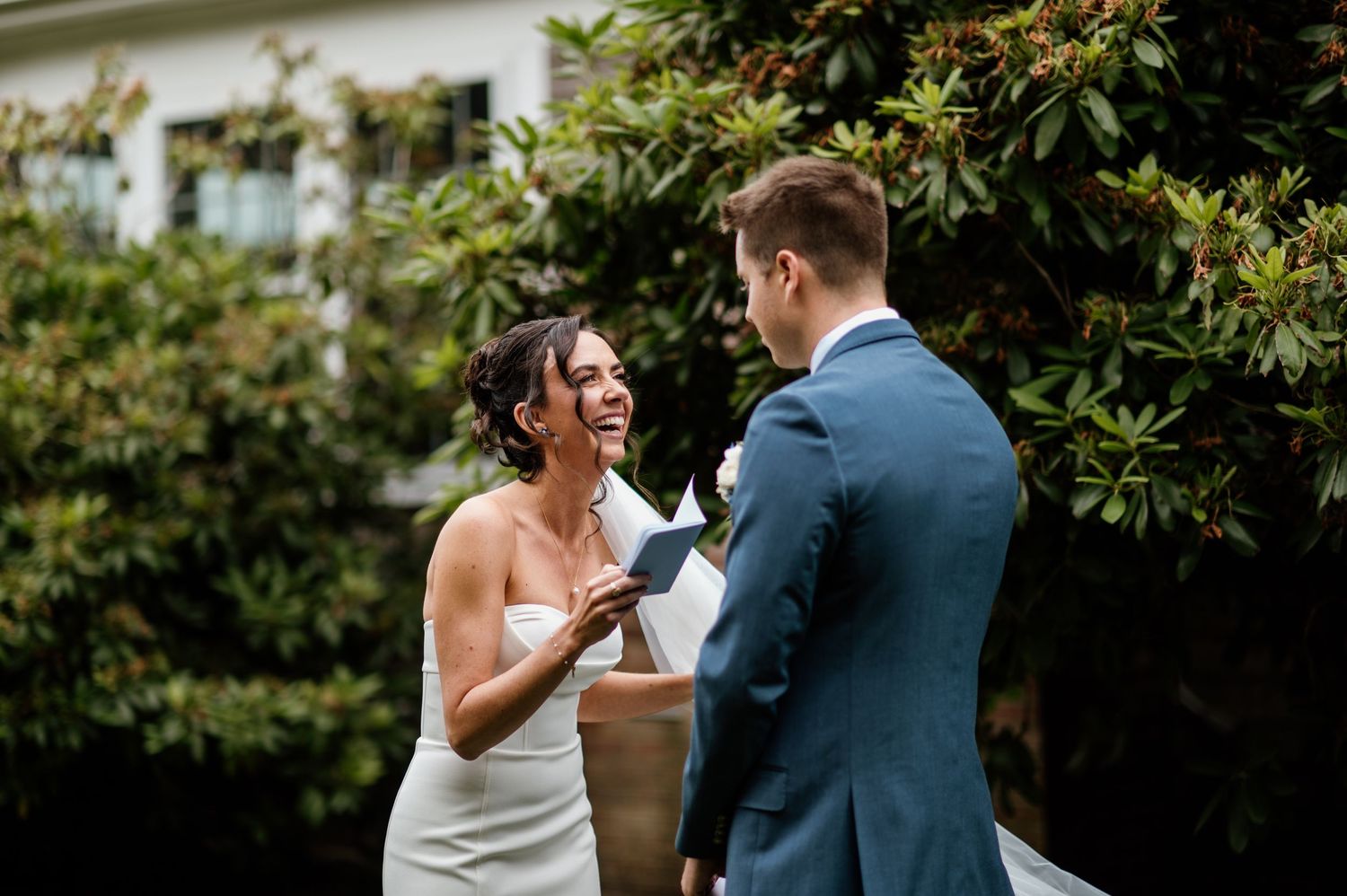Couple sharing intimate moment during outdoor garden wedding ceremony.