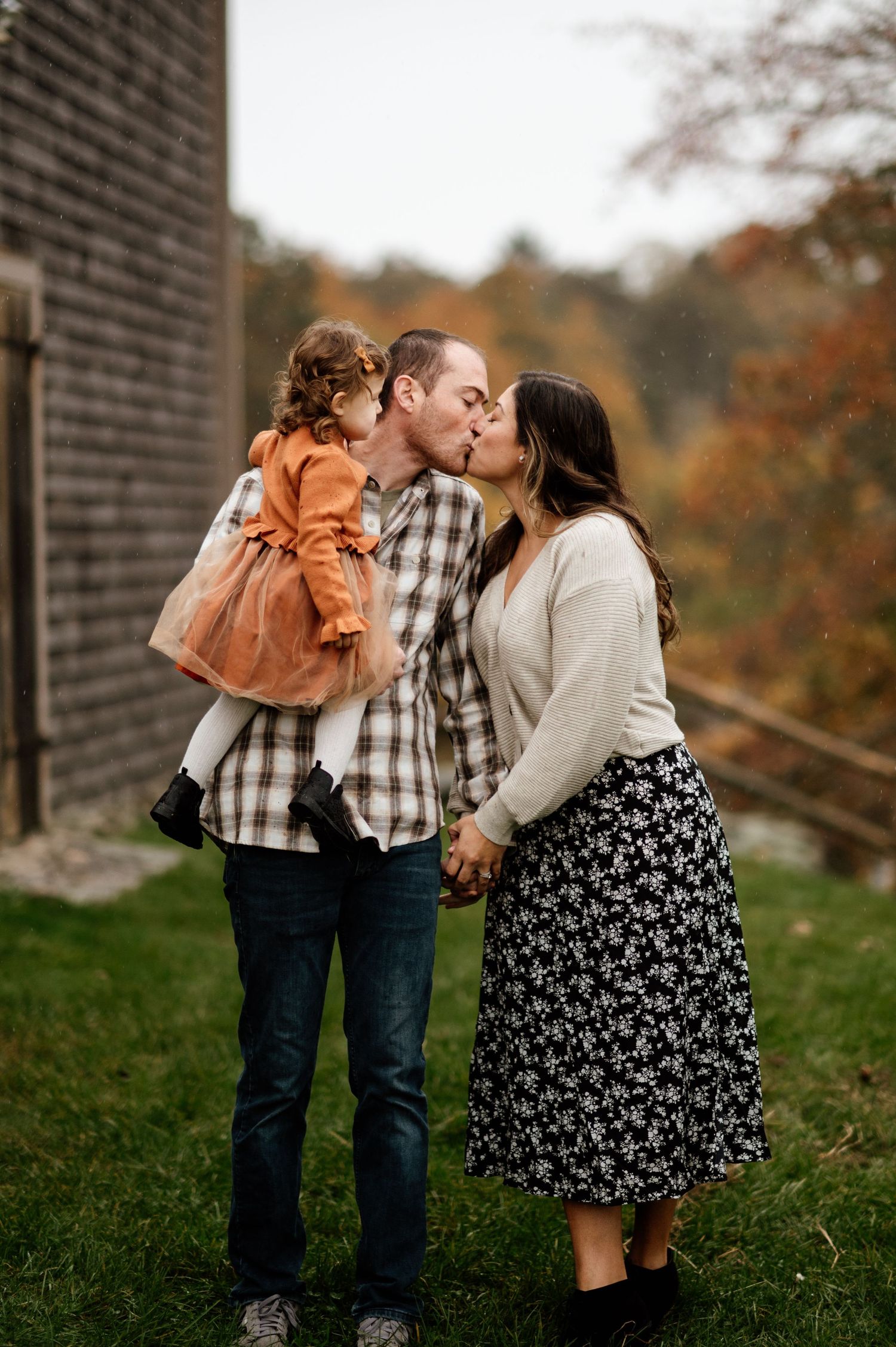 Family sharing intimate moments together outdoors during autumn.