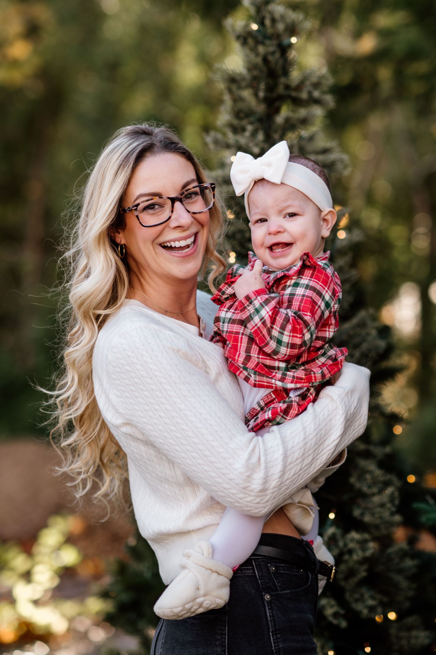 Outdoor autumn photoshoot featuring joyful moments in a white sweater and plaid outfit.