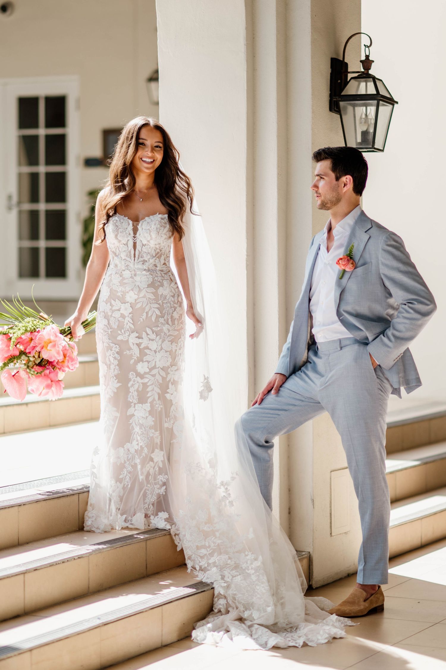 Romantic wedding photo sequence showing bride in lace dress and groom in gray suit posing along a sunlit colonnade.