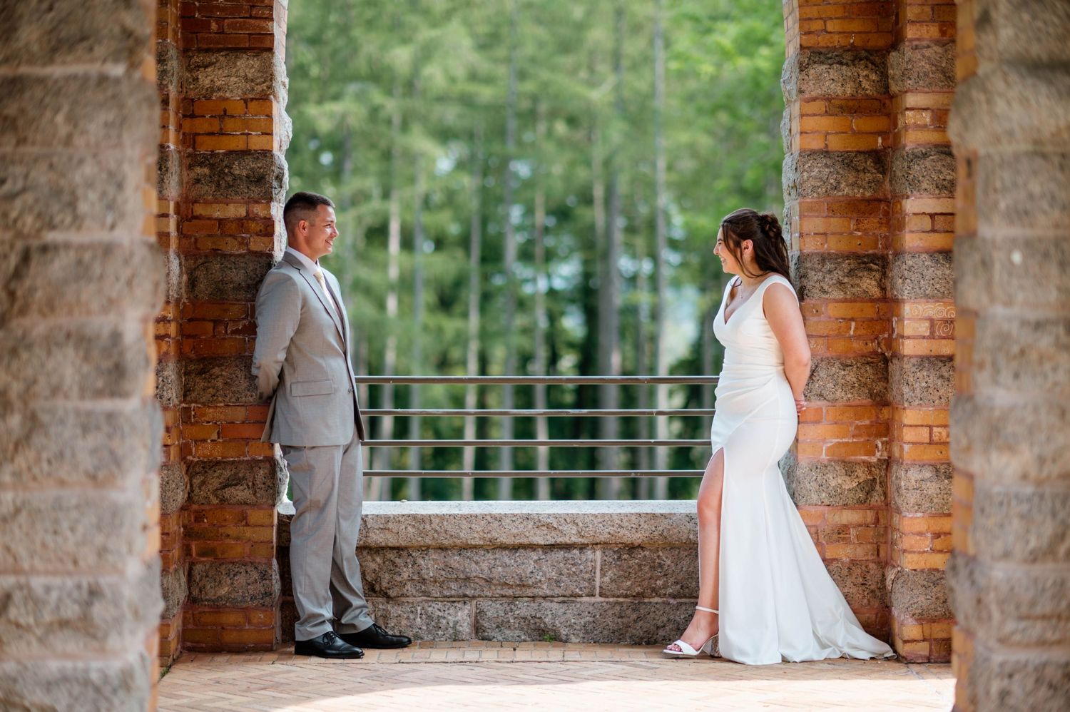 A romantic wedding photo session in a rustic brick archway setting.