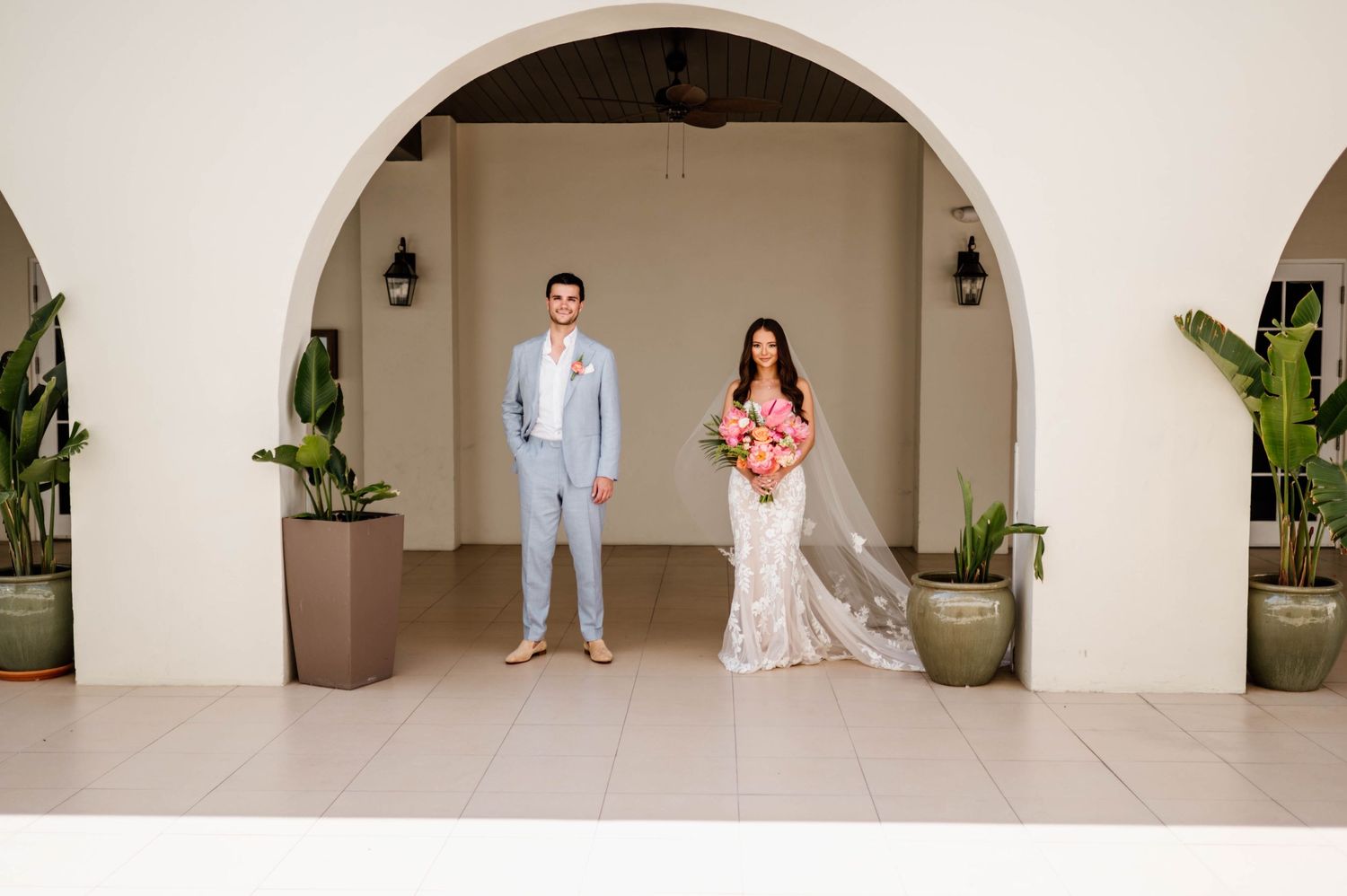 A series of wedding photos in a light and airy venue with white archways and potted plants along the walls.
