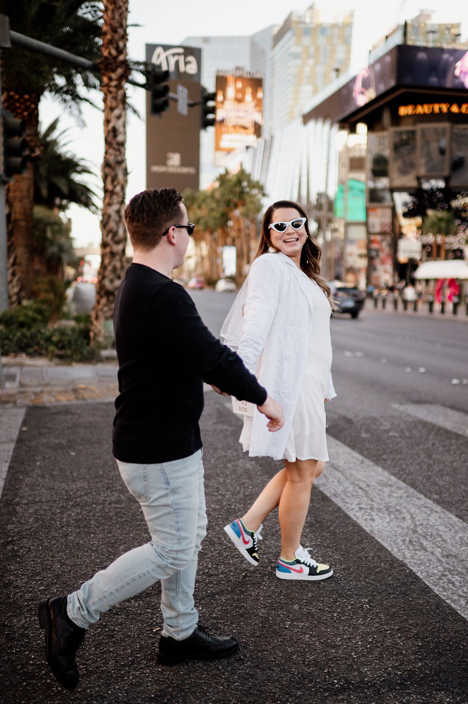 A playful street photography sequence showing a couple dancing on an urban sidewalk.