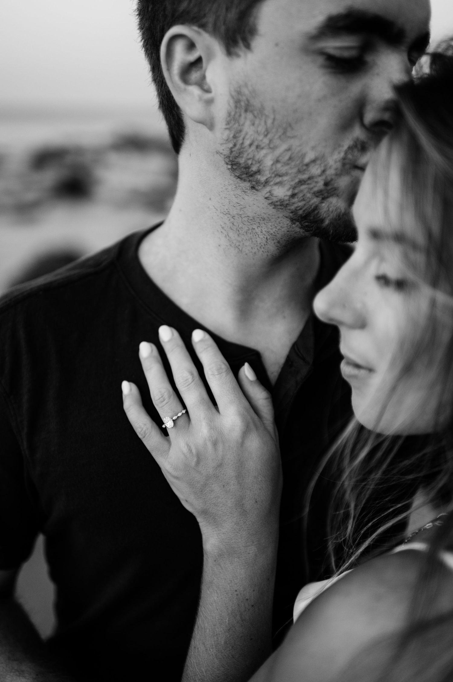 Intimate black and white close-up portraits of couple showing tender moments and engagement ring.
