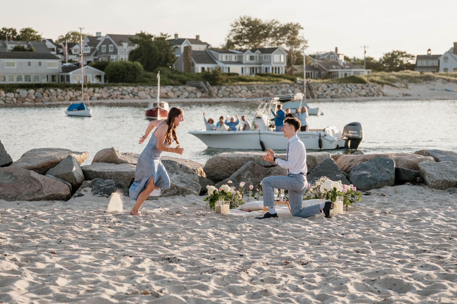 A series of beachside engagement photos showing romantic moments at sunset along a rocky shoreline.