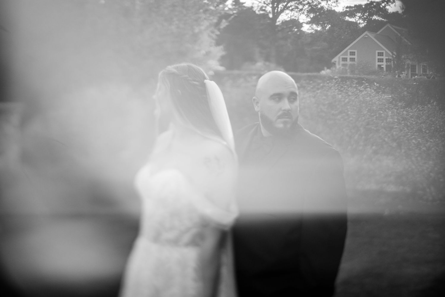 Black and white artistic wedding photography with soft focus and dreamy effects.