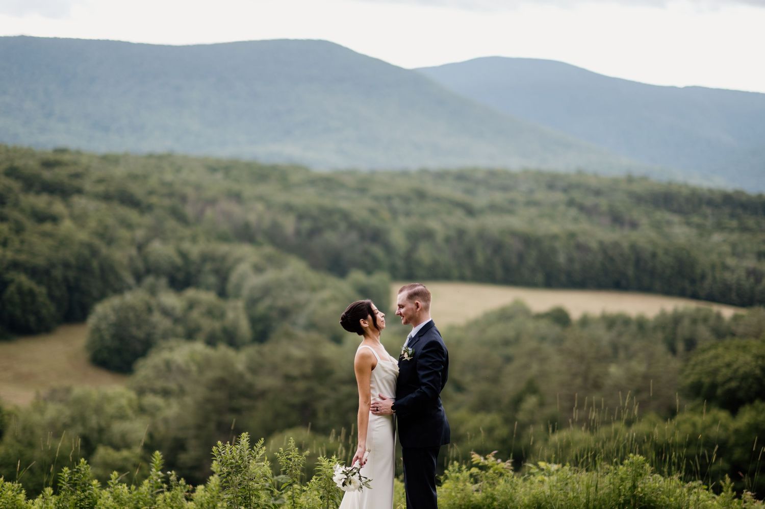 Wedding portraits set against a stunning mountain landscape backdrop.