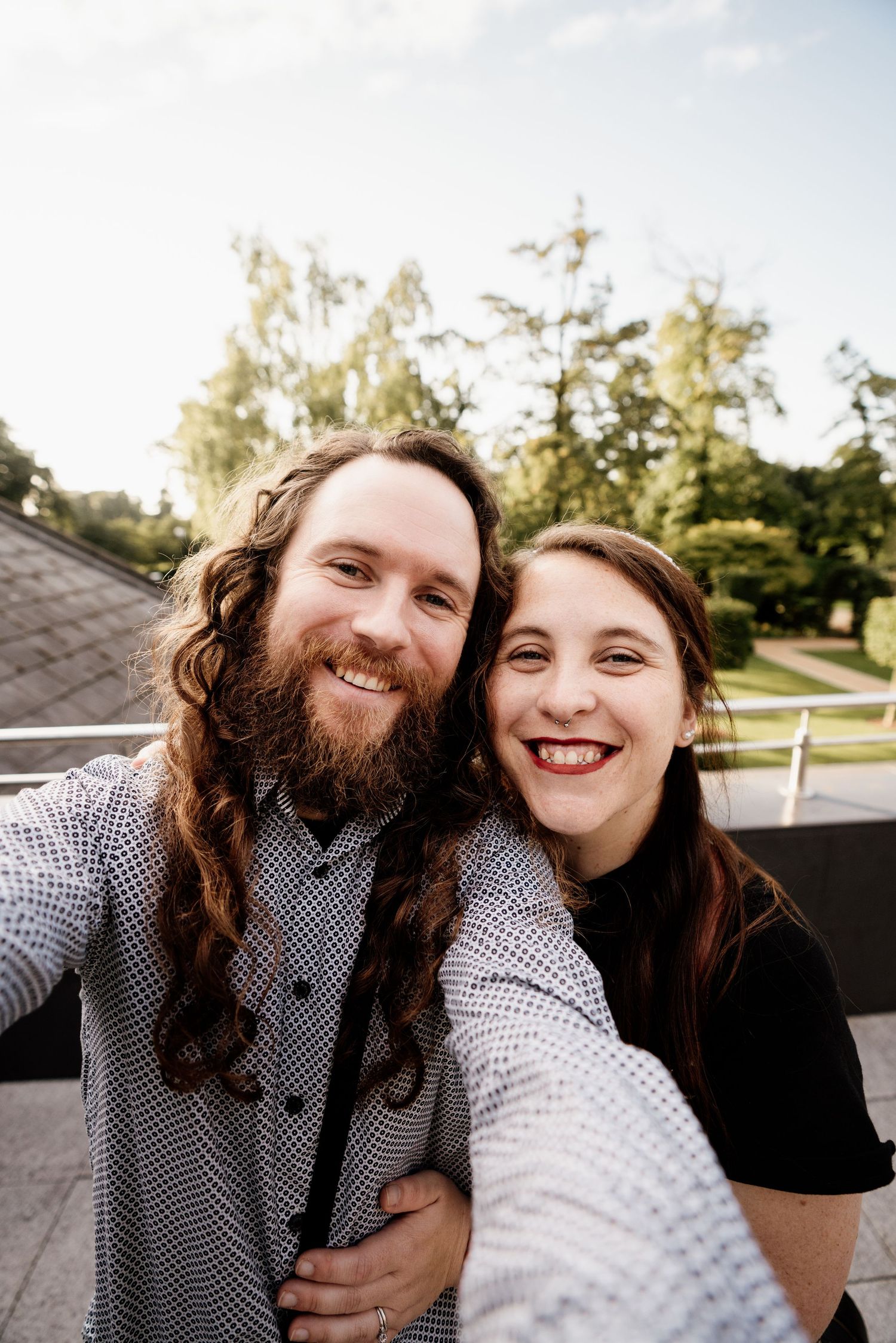 A couple shares joyful laughter together in a series of candid outdoor portrait photos.