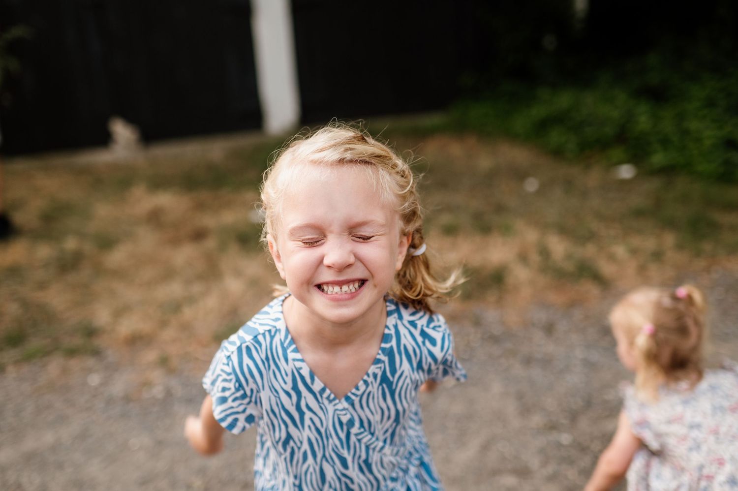 Series showing children playing and laughing outdoors in blue patterned clothing.