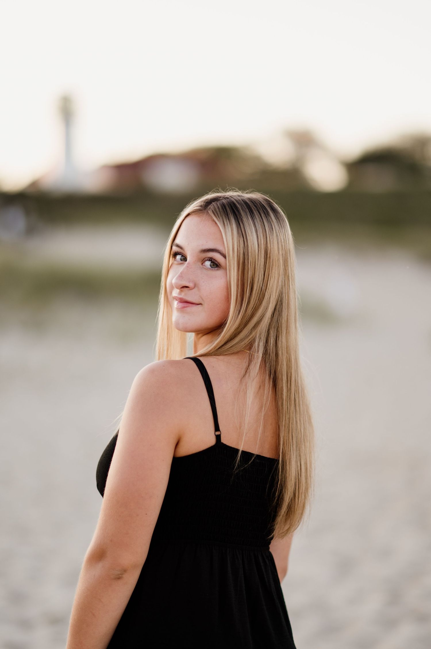 A woman in a black dress poses on a beach at sunset, showing different angles in a photo collage.