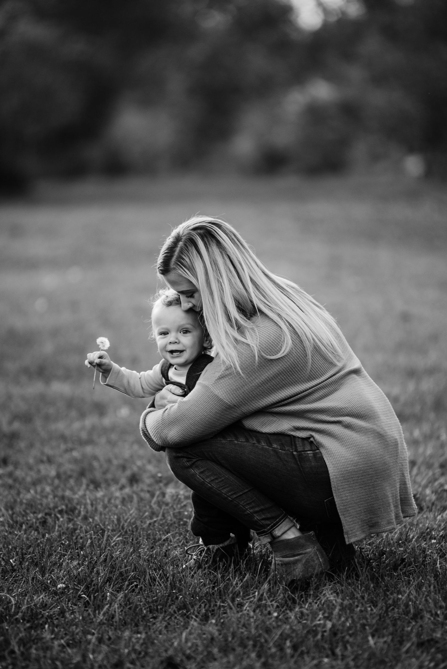 Black and white photos showing playful moments in a grassy field.