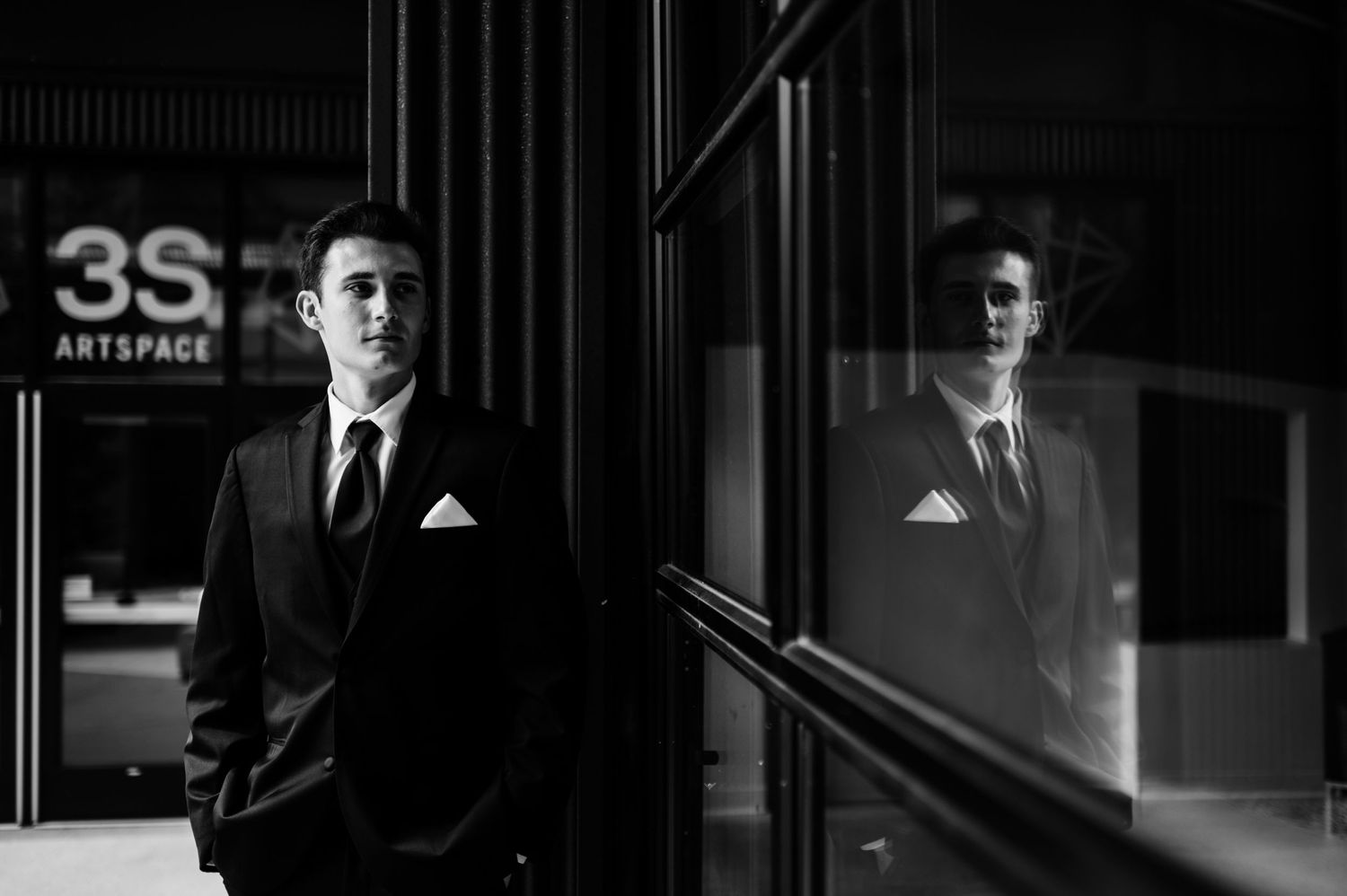 Dramatic black and white wedding portraits in an urban setting with strong contrast.