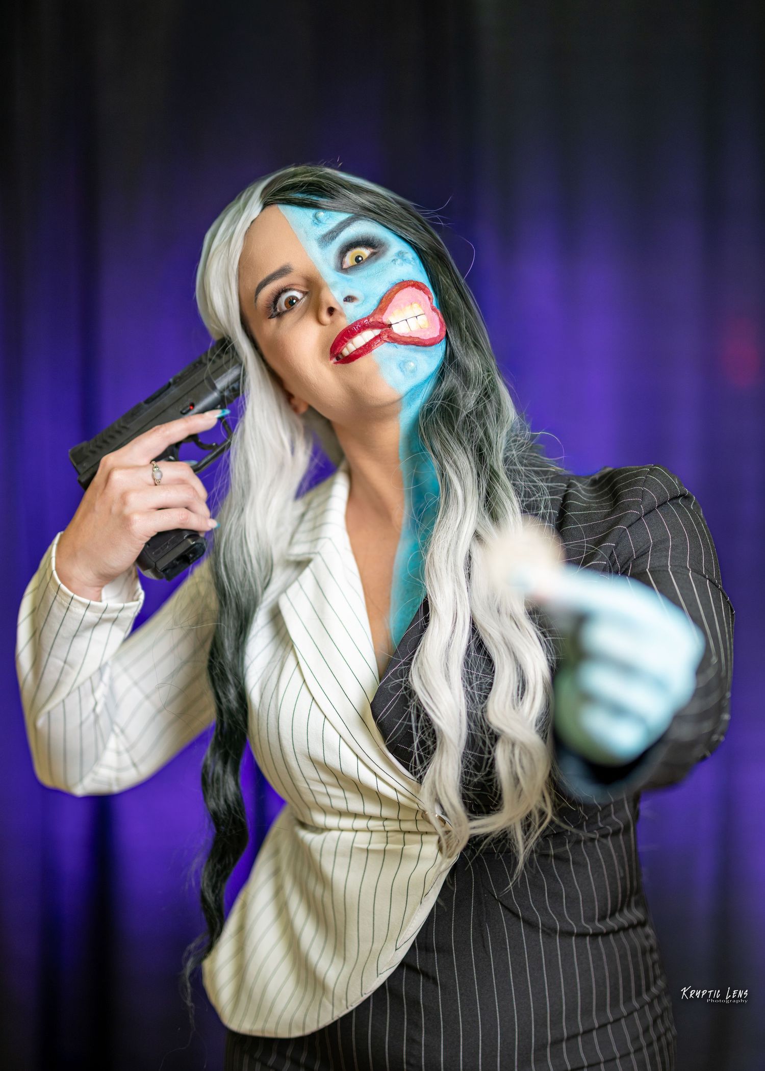 Cosplayer in black and white pinstriped outfit makes dramatic poses against purple background.
